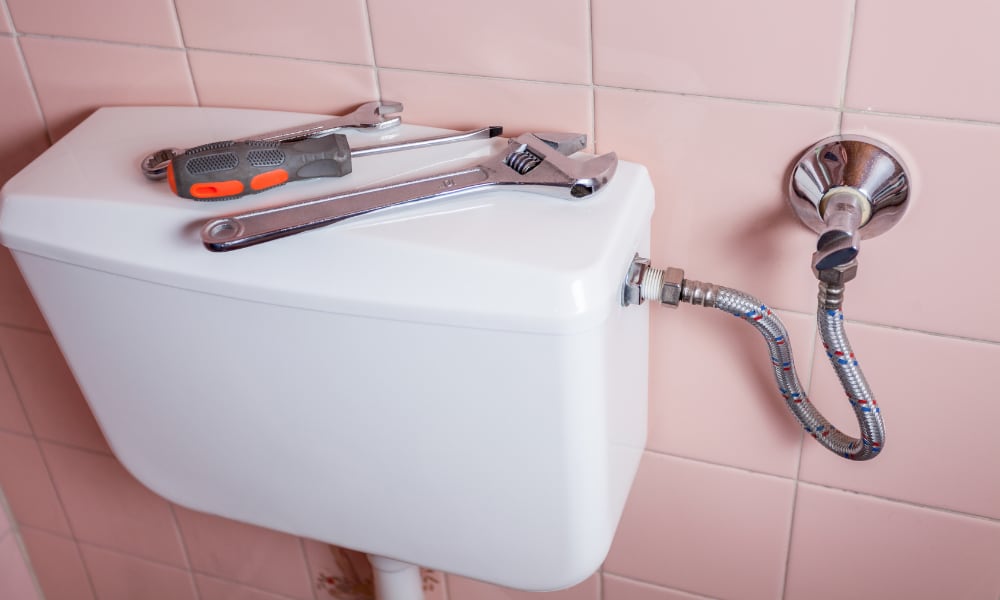 plumbing tools on toilet tank